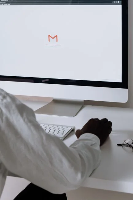 Vertical shot of a smartphone displaying an Instagram profile next to a laptop, representing social media engagement.